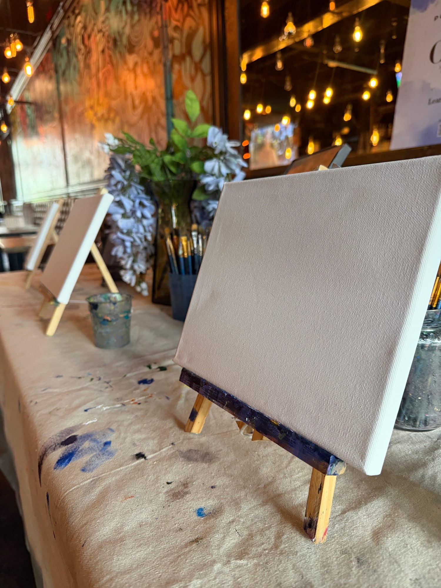 Small wooden stool with gold accents against a blurred indoor background